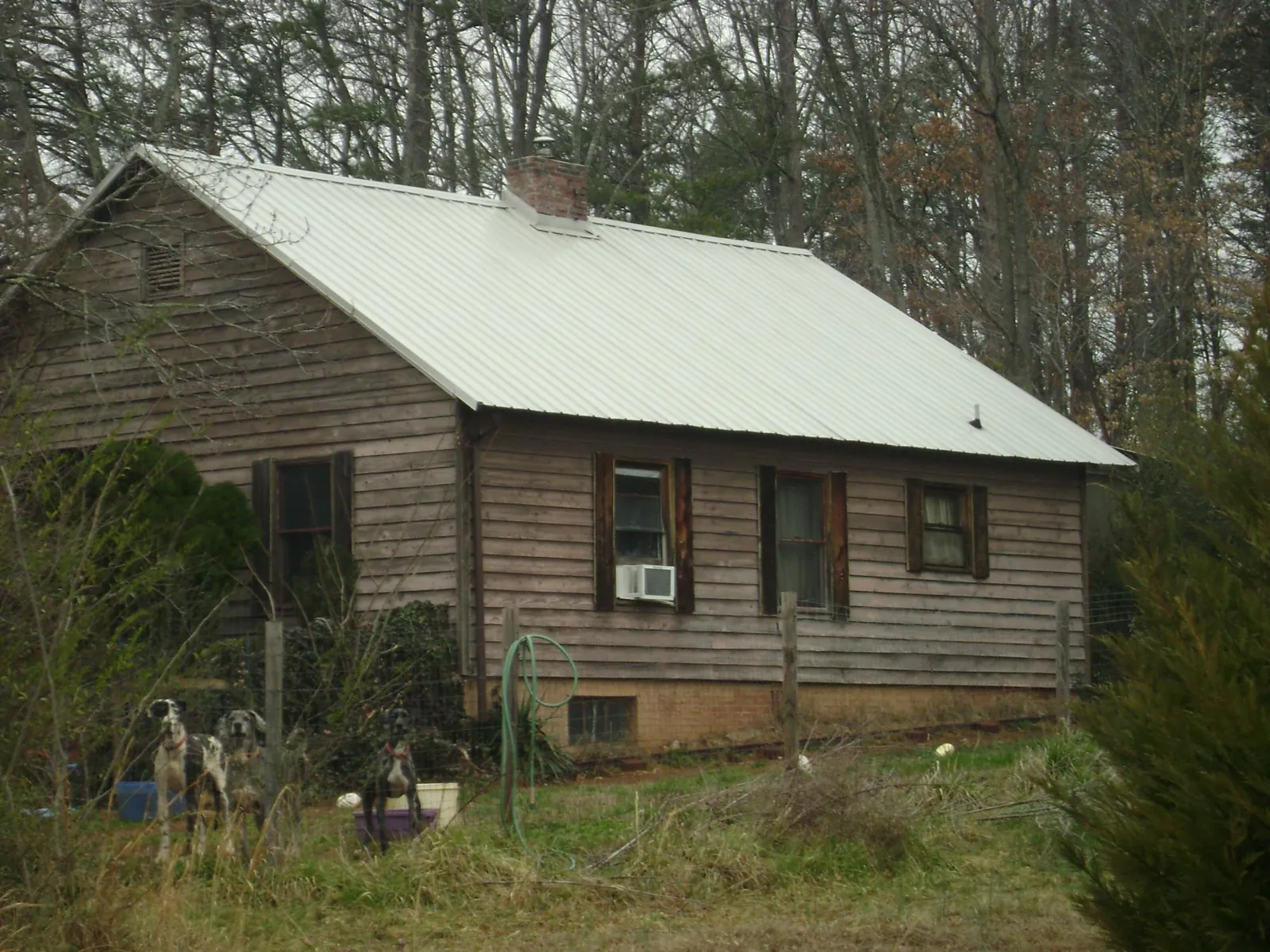 White metal roof on an old wood sided farmhouse, from a Metal Roof Installation job in New Canton